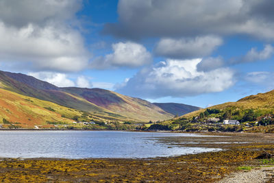 Scenic view of lake and mountains against sky