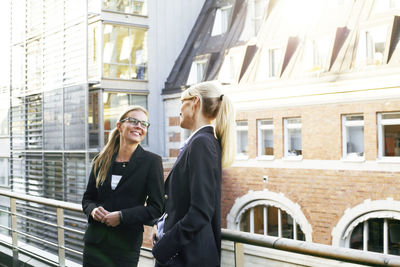 Smiling businesswomen talking on terrace