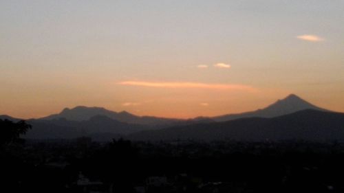 Scenic view of silhouette mountains against sky at sunset