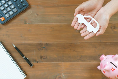 High angle view of person holding camera on table