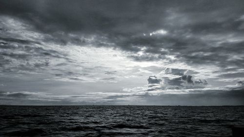 Scenic view of sea against storm clouds