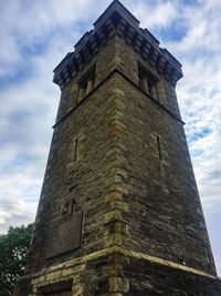 Low angle view of tower against cloudy sky