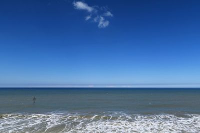 Scenic view of sea against blue sky