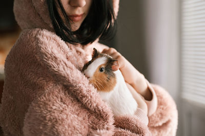 Portrait of young woman with teddy bear