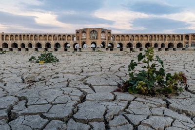 Ancient structure against cloudy sky
