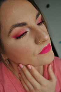 Close-up of beautiful young woman with make-up