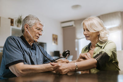 Senior couple taking blood pressure