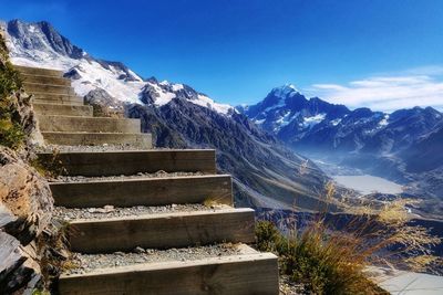 Scenic view of snowcapped mountains against blue sky