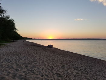 Scenic view of beach against sky during sunset