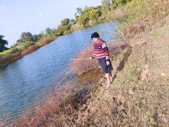 Rear view of boy on shore