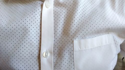 Close-up of white button down shirt