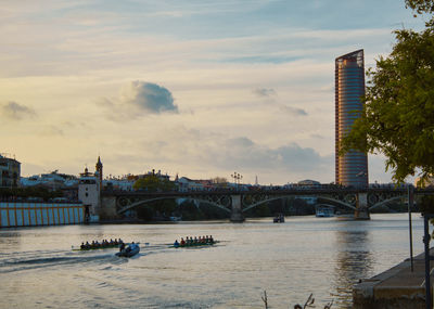 Bridge over river against buildings in city