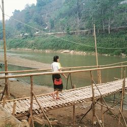 Full length of woman standing by railing