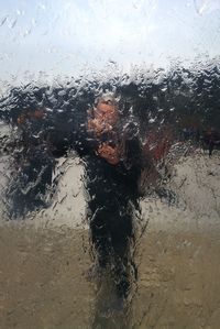 Portrait of wet glass window during rainy season