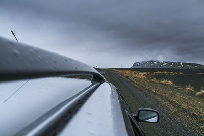 Close-up of car on mountain against sky