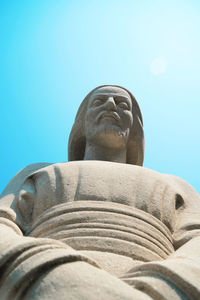 Low angle view of statue against clear blue sky