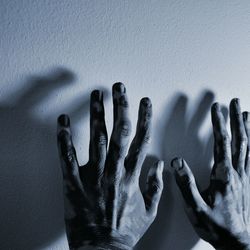 Cropped hands against white wall