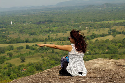 Rear view of woman on landscape against mountains