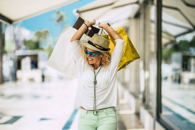 Midsection of woman wearing hat standing outdoors