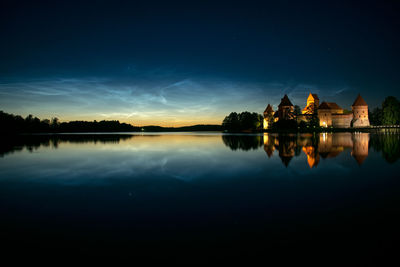 Scenic view of lake against sky at night