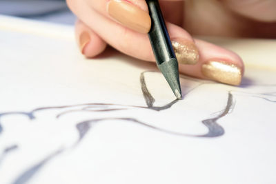 Close-up of human hand holding paper