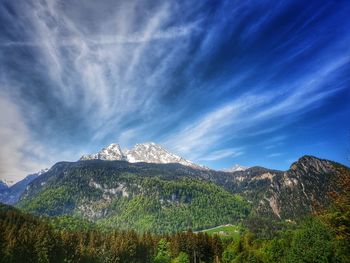 Scenic view of mountains against blue sky