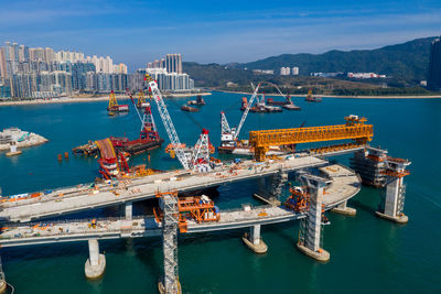 Commercial dock by sea against sky