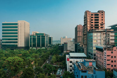 Buildings in city against clear sky