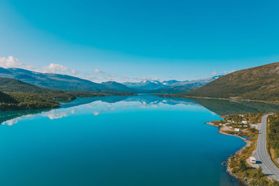 View of lake by mountain against sky