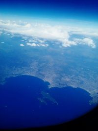 Aerial view of sea against blue sky