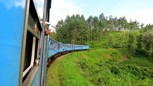 Train by railroad tracks against sky