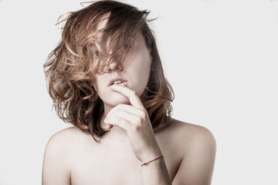 Close-up of shirtless boy over white background