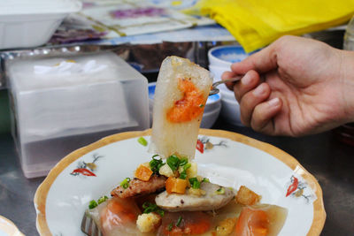 Close-up of man holding food in plate