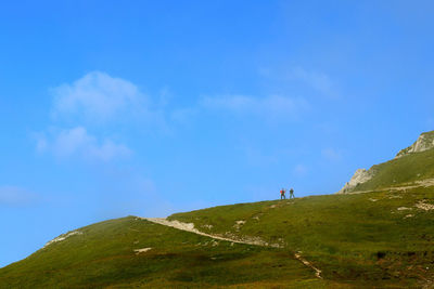 Scenic view of land against blue sky