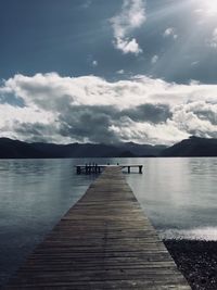 Pier over lake against sky