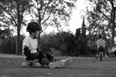 Boy is sitting on his longboard