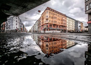 Reflection of buildings in puddle