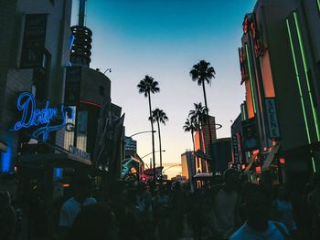 Low angle view of crowd in city against sky