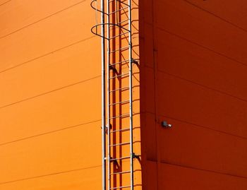 Full frame shot of orange building during sunny day