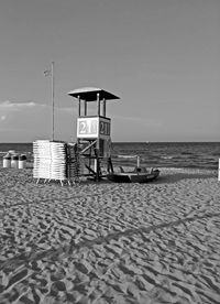 Lifeguard hut on beach against sky