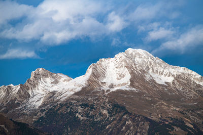 Low angle view of snowcapped mountain against sky