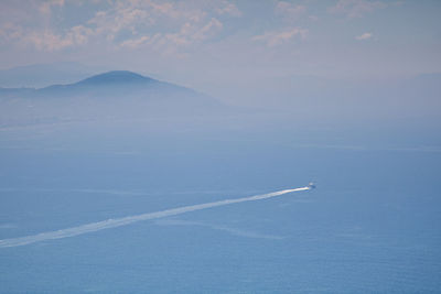 Aerial view of mountain and boat in mist