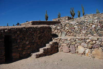 Stone wall against clear blue sky