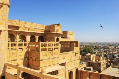 View of buildings in city against clear sky
