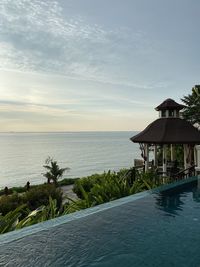 View of swimming pool by sea against sky