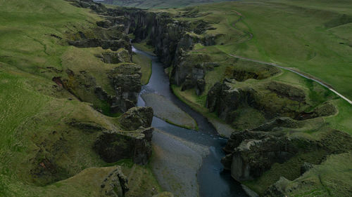 High angle view of river flowing amidst land