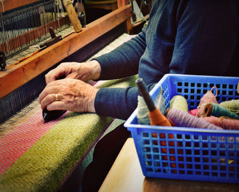 Midsection of man holding basket