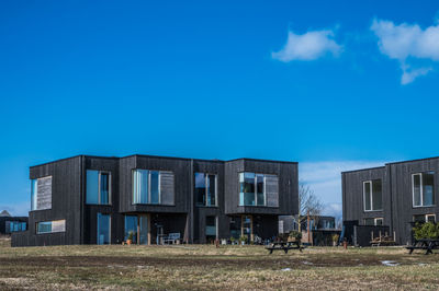 Low angle view of buildings against blue sky