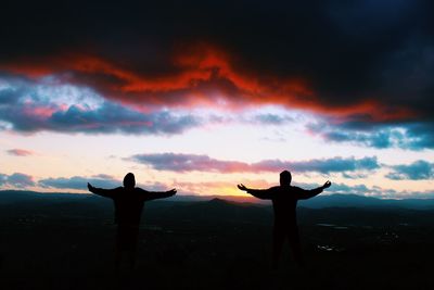 Silhouette of people at sunset