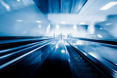 Blurred motion of illuminated escalator